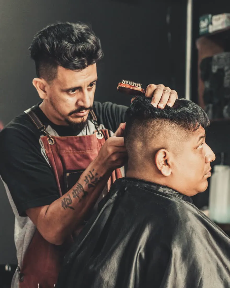 A barber cutting a client's hair