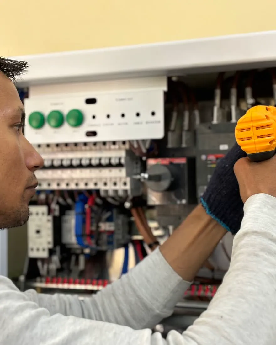 An electrician working on a fuse board